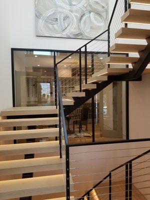 Floating staircase with wine room views