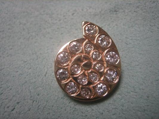 Custom made 14 karat yellow gold and diamond ammonite shell shaped pendant