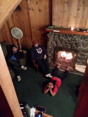 Family enjoying the nice cozy fireplace