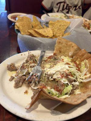 Taco salad with unseasoned meat in queso (?) just tasted like a bland slimy something.