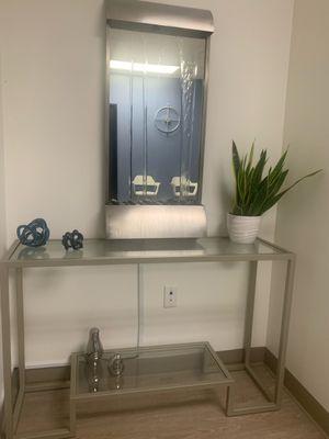 Mirror fountain on console table and other decor.