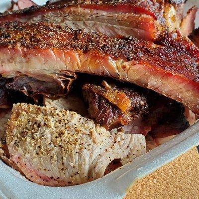 Close up of sliced, smoked pork shoulder and pork ribs