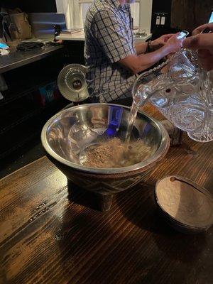 Pour the water into the bowl with the kava powder