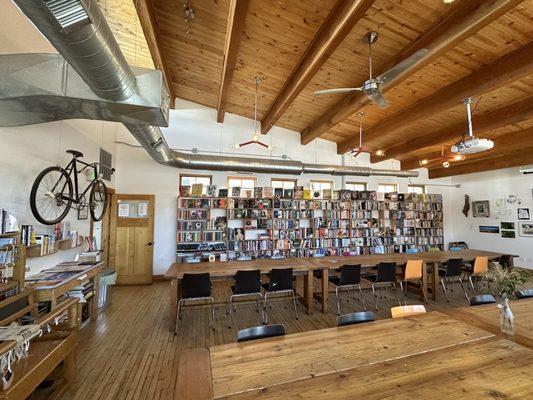 Gorgeous meeting space with shelves of various books.  Love the bicycle on the wall!