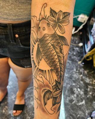 Filipino sun with koi tattoo