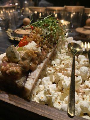 Roasted Bone Marrow + Beef Tartare $22 caper + gerkin remoulade, potato crisps, black garlic aioli, grated horseradish