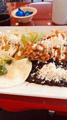 Chilaquiles Diego y Frída with over medium eggs and black beans One pancake