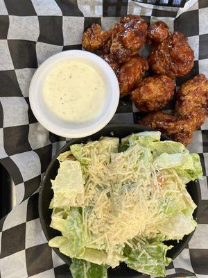 Boneless wings with Gochujang Sauce served with a side caesar salad