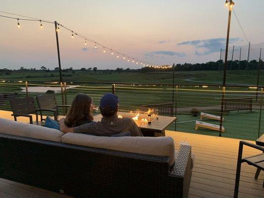 Comfortable furniture with firepits overlooking the golf course