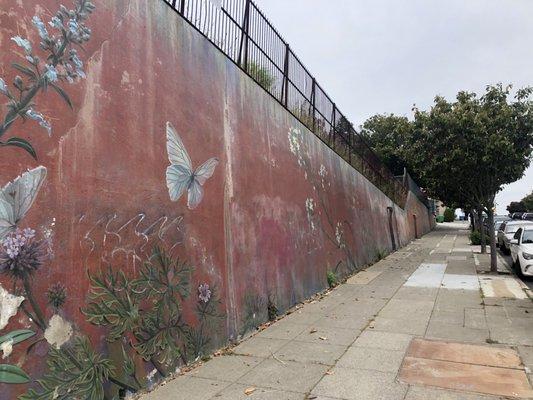 The retaining wall on Church St has an early  Mona Caron WEEDS mural (though some of the paint came off in the recent winter storms).