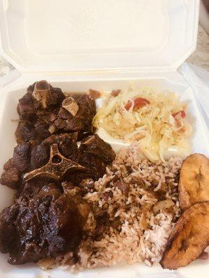 Oxtail, rice&peas with steam cabbage and plantains.