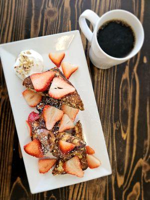 French Toast Almondine with house made cinnamon babka bread, almond infused whip cream, and strawberries