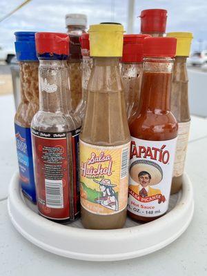 Solid condiment and sauce selection on the table.