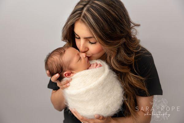 Newborn baby boy and his mom during their newborn session at Sara Pope Photography