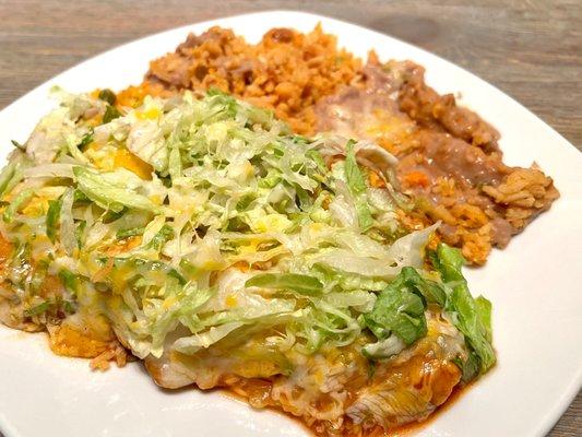 Chicken Enchilada (2) Plate. Topped with lettuce & cheese. Comes with delicious refried beans & fluffy rice. Love this dish!