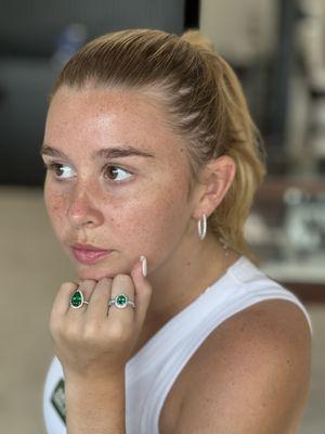 Emerald and diamond rings and diamond hoop earrings