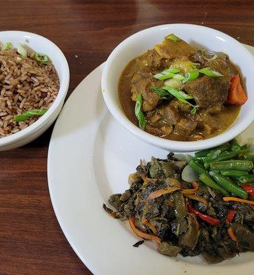 Curried goat, string beans/callaloo, rice and beans.