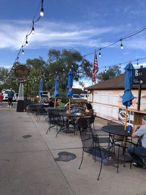 Outdoor seating. The building with the white wall is Red Barn Creamery