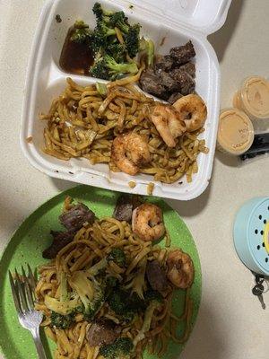 Beef and shrimp combo with noodles and broccoli..