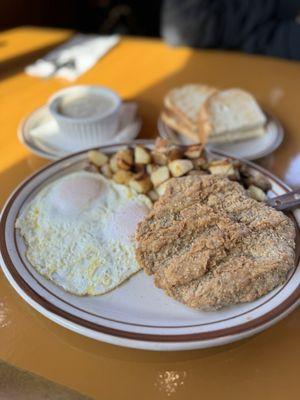 Country fried steaks with country potatoes, over easy, eggs, and sourdough toast