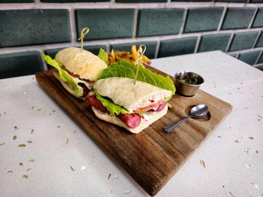 Choripan: 
Chorizo, chimichurri, mayo, homemade bread, lettuce and tomatoes. French Fries