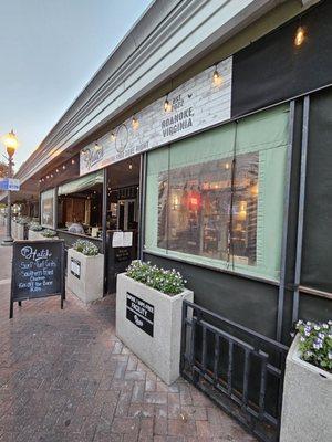 The outside seating area of the restaurant with some curtains to protect from the cold and wind.