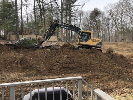 Excavating the rocks and stumps