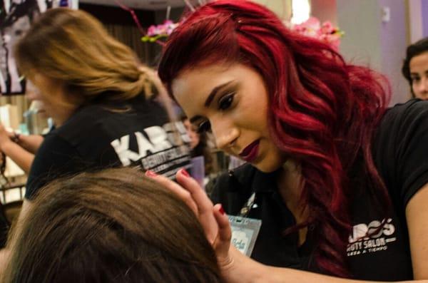 Make up artist Alicia A. At work with model at Quinceañera expo