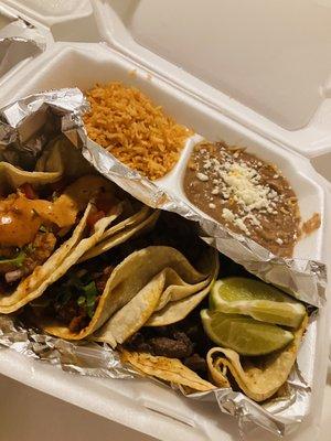 Shrimp taco, Barbacoa taco, and carne asada taco with rice and beans