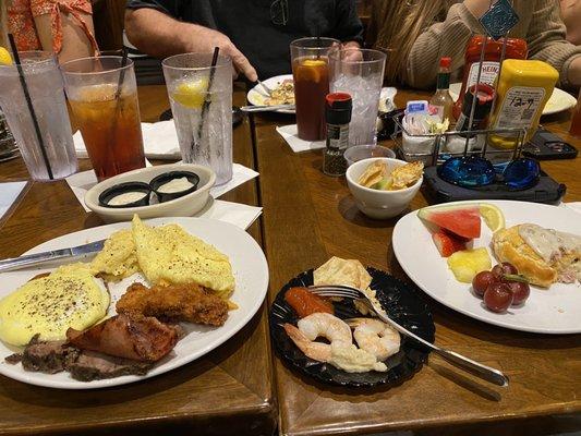 Eggs Benedict, prime rib, ham, chz omelet, biscuits and gravy, fruit, shrimp cocktail and mahi fish dip,