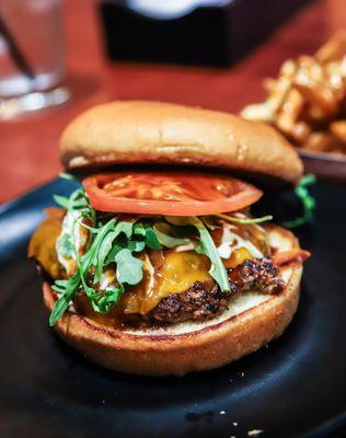 Kenji Burger - 
 Teriyaki, ponzu aioli, caramelized onions, Cheddar cheese, tomato and arugula. We use 100% Kauai grass-fed beef.