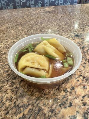 Won ton soup in a sauce container