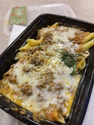 Penne pasta with creamy tomato & meat sauce topped w/ cheese