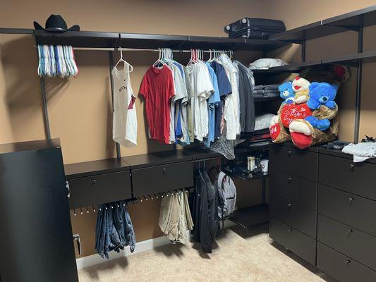 Before redesign with clothes. Storage door is blocked and the shelves on right are blocked by drawers.