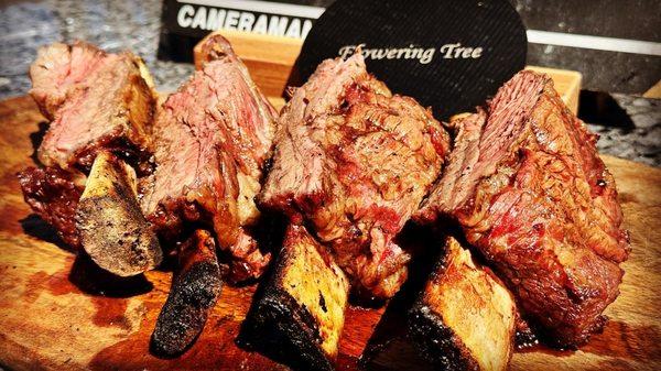 Savage and fantastically delish BBQ short ribs  created on a rustic grill - experience the magic of short rib BBQ heaven!