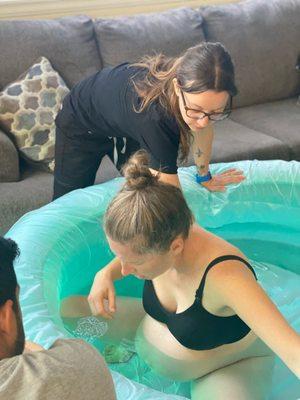 Becca supporting client's water birth at home.