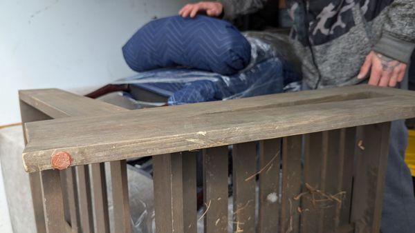 Damaged patio furniture, layered wood on top of wood/ metal on top of wood