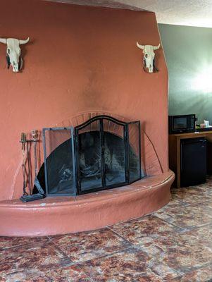 Fireplace, complete with soot grime and chipped paint.