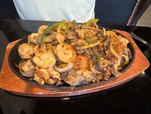 Trio fajitas- chicken, steak, and shrimp with mushrooms peppers and onions