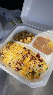 Migas con huevo y chorizo, acompañado de papas y frijoles. Chilaquiles with egg and chorizo, potatoes and beans on the side.