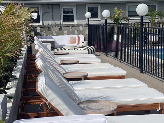 Lounge chairs by pool. They have umbrellas too but this is early in morning