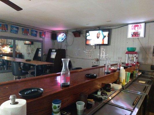 Bar seating with three TV's and popcorn machine.