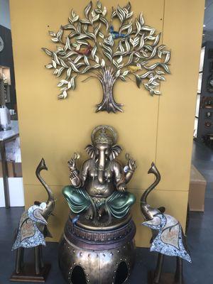 Lord Ganesha with a beautiful wall hanging of a tree and in between two decorative elephants