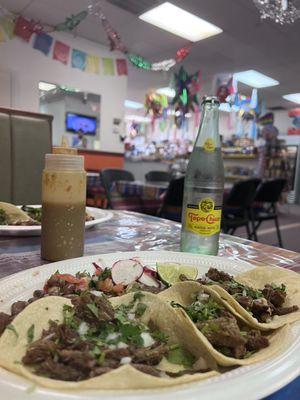 Barbacoa and carne asada tacos with a view of the market