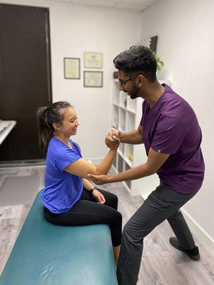 Performing a muscle test to examine the functionality of this patient's biceps.