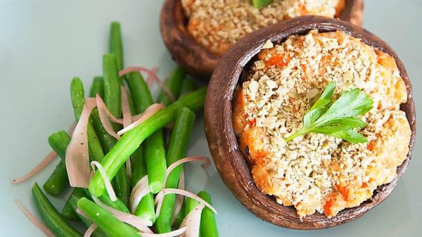 Oven roasted Portobello mushrooms stuffed with roasted root vegetables, topped with toasted pumpkin seed crumbs.