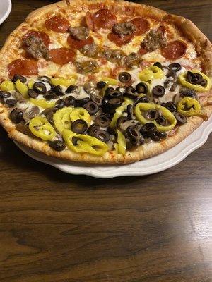 Half pepperoni and sausage, half olives mushrooms and banana pepper yummmm