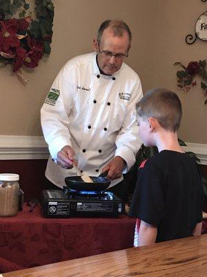 Todd showing my son how he makes bananas foster..