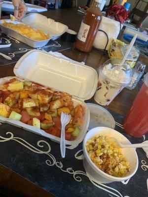 Fruit plate, fresas con crema and cheesecake bites, corn in a cup