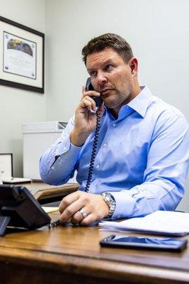 Personal injury lawyer, Alex Silkman talking on the phone with an insurance company